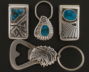 A set of turquoise money clips and a handmade silver bottle opener key ring.